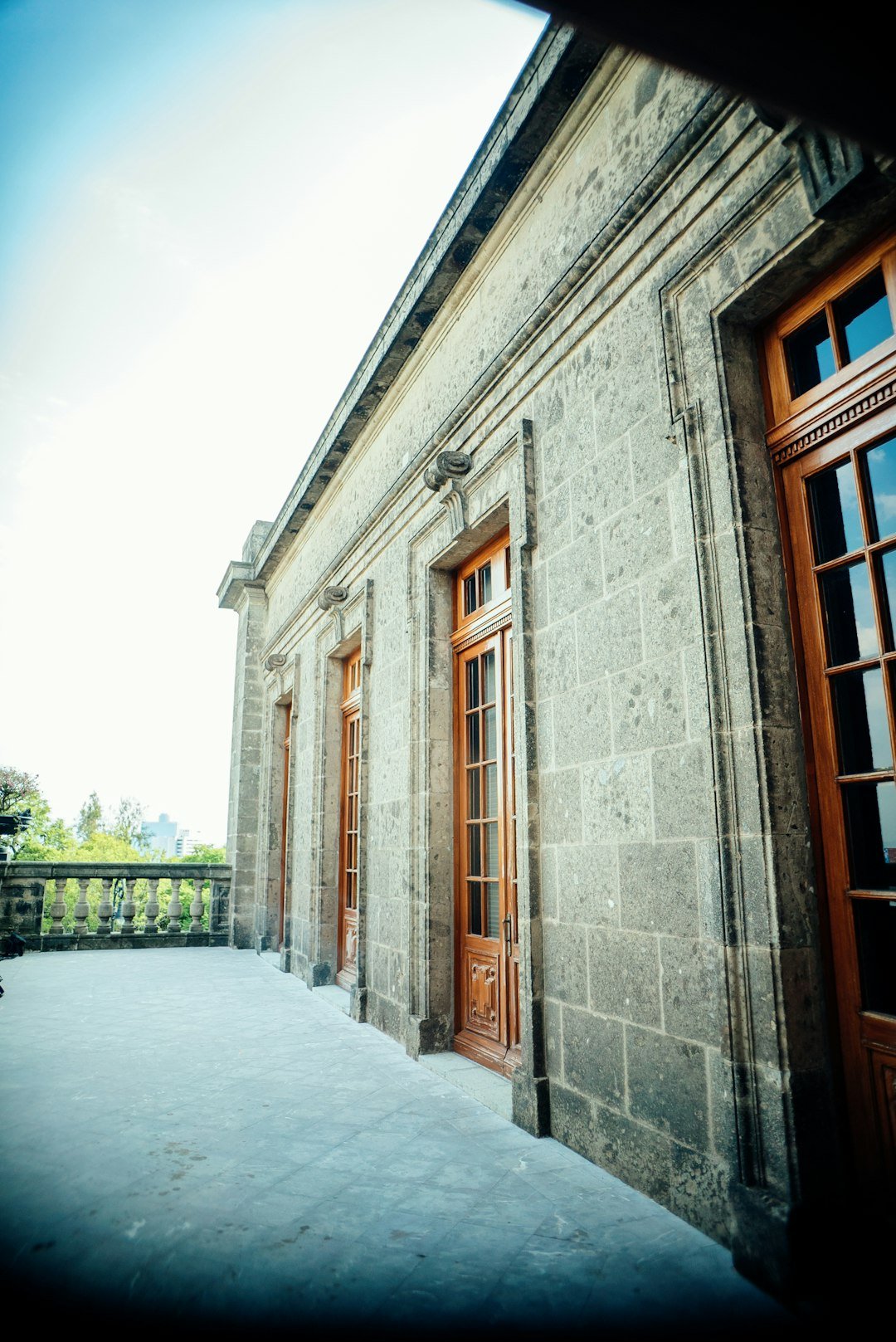 a stone building with two doors and a balcony lkovlze0vcq